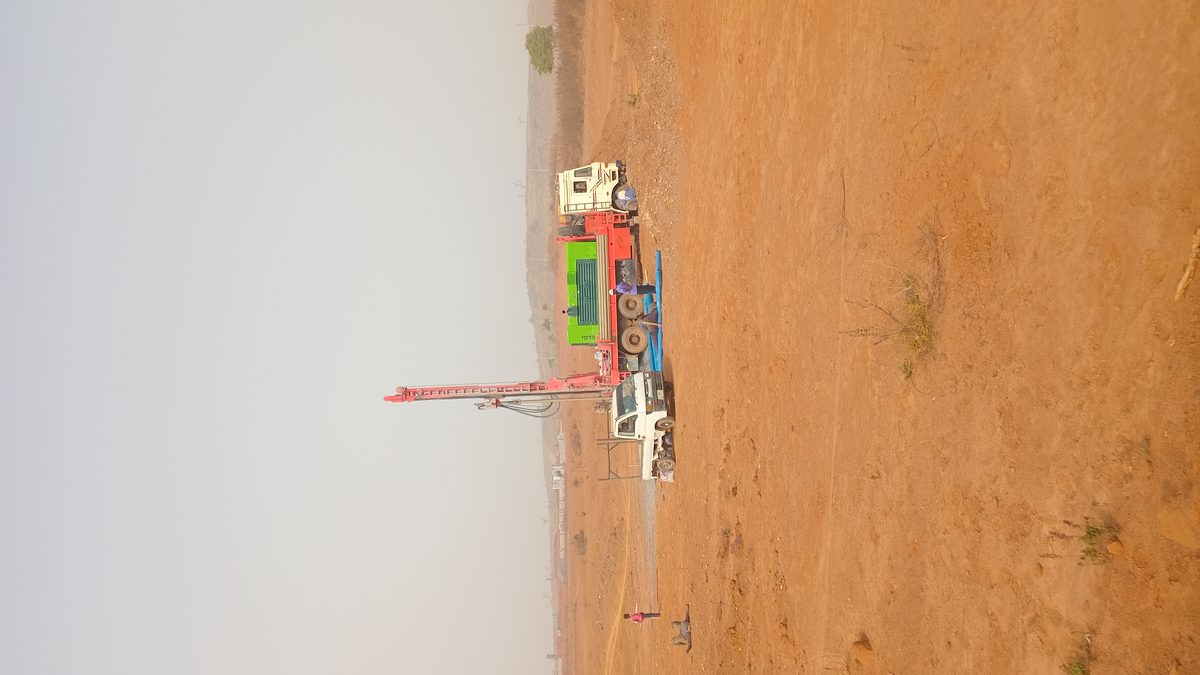 Machine drilling rig on open field