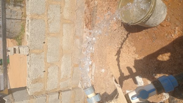 Worker testing borehole water